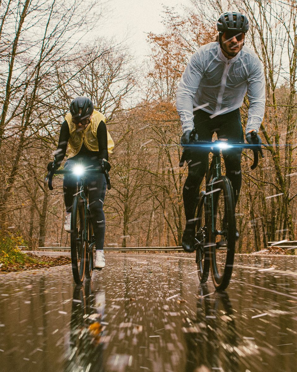 Wind jacket — two riders on a wet forest road